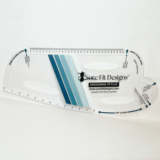A clear plastic French Curve tool with blue and black markings for pattern drafting, branded by Sure Fit Designs.