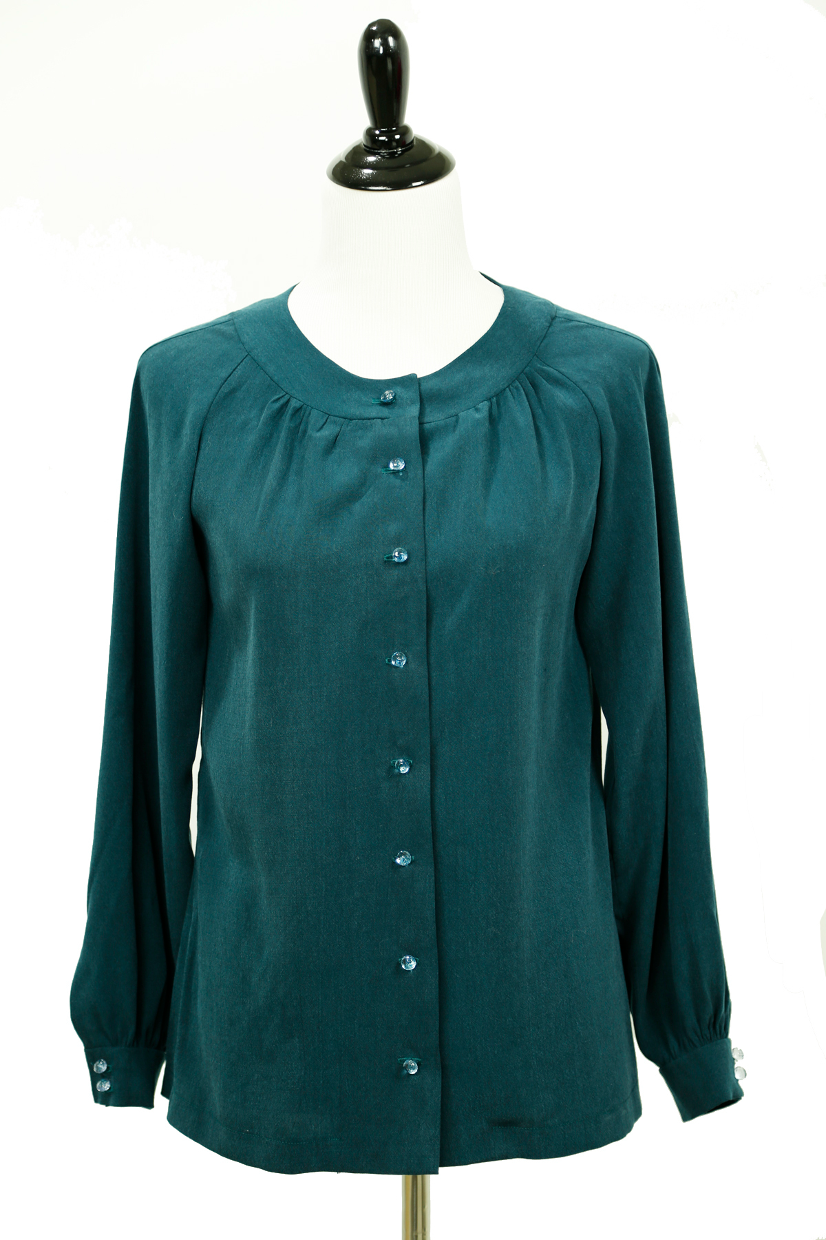 A digital sewing PDF for A long sleeved button up blouse.  the garment on the mannequin is green