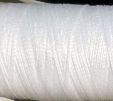 a spool of white Gütermann Maraflex stretch thread