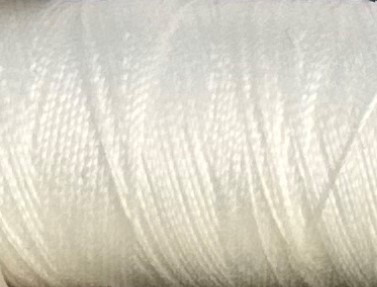 a spool of ivory Gütermann Maraflex stretch thread