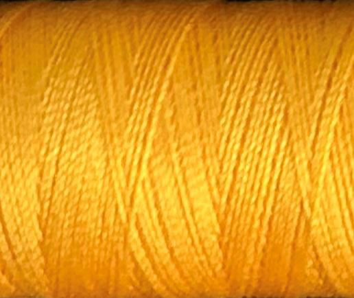 a spool of marigold Gütermann Maraflex stretch thread