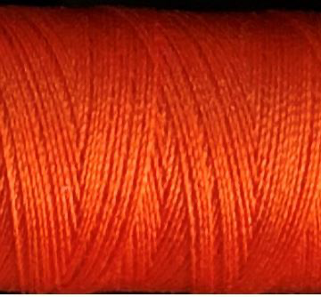a spool of orange Gütermann Maraflex stretch thread
