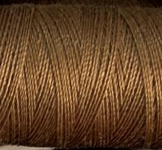 a spool of light brown Gütermann Maraflex stretch thread