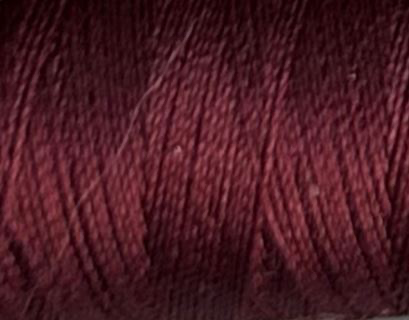 a spool of wine colored Gütermann Maraflex stretch thread