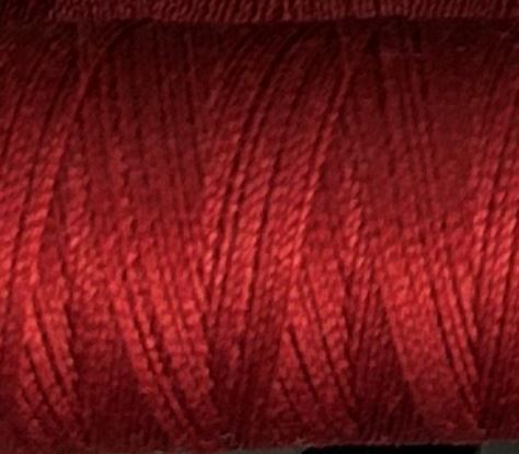 a spool of brick red Gütermann Maraflex stretch thread