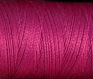 a spool of fuchia colored Gütermann Maraflex stretch thread