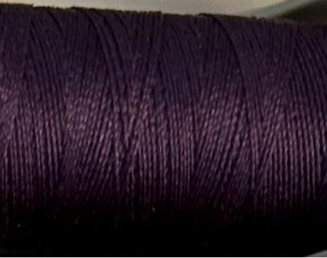 a spool of plum purple Gütermann Maraflex stretch thread