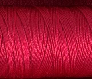 a spool of vibrant pink Gütermann Maraflex stretch thread