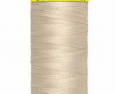 Spool of beige Gütermann Maraflex thread with a visible brand label on a white background