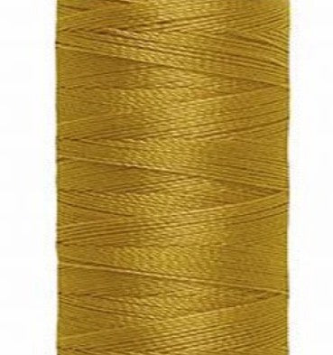 Spool of yellow Gütermann Maraflex thread on a white background